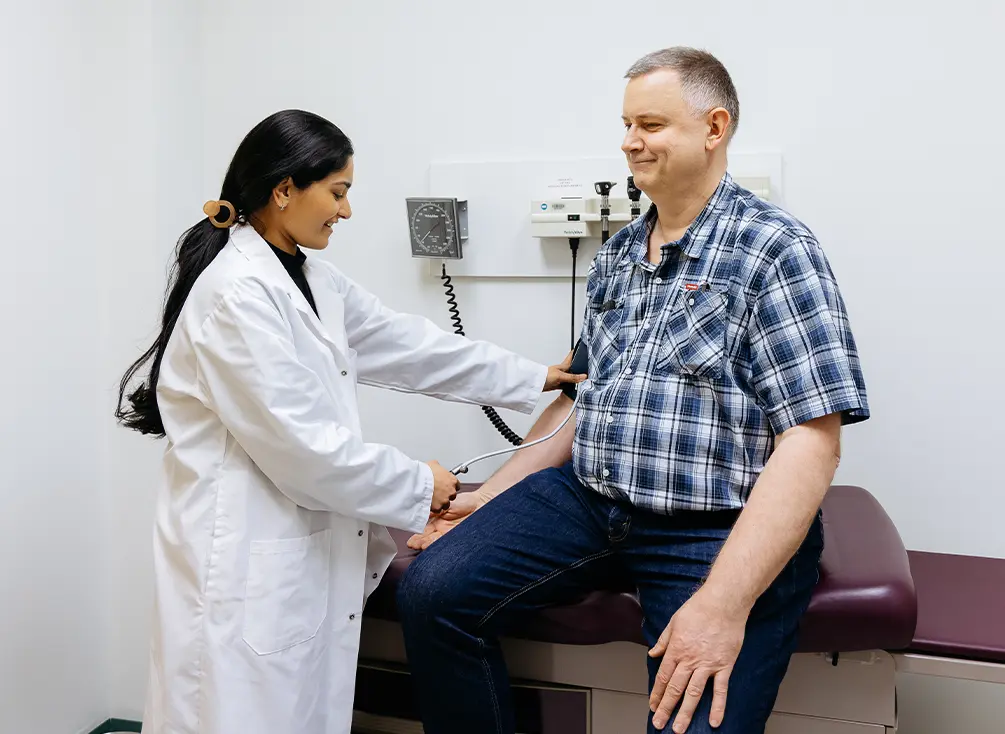Dr. Singh checks a person’s blood pressure, the #1 risk factor for stroke.