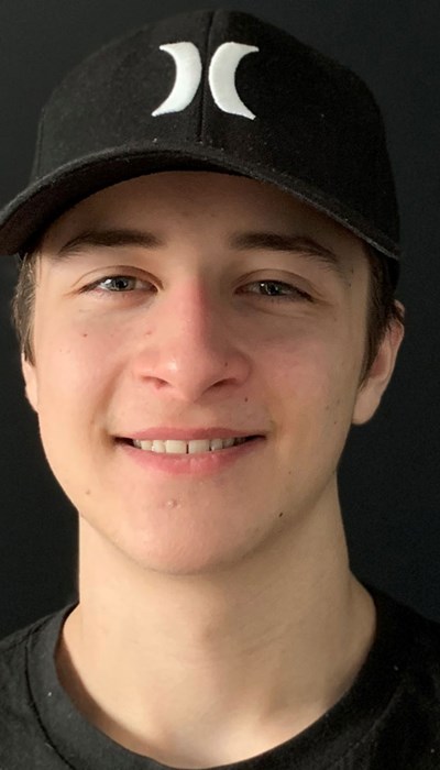 Olivier Lanthier smiles in a dark top and baseball cap