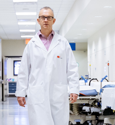 Dr. Philip Barber walks down a corridor of Foothills Medical Centre