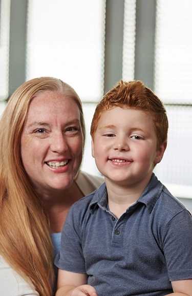 Portrait of young Charlie sitting on his mom's lap