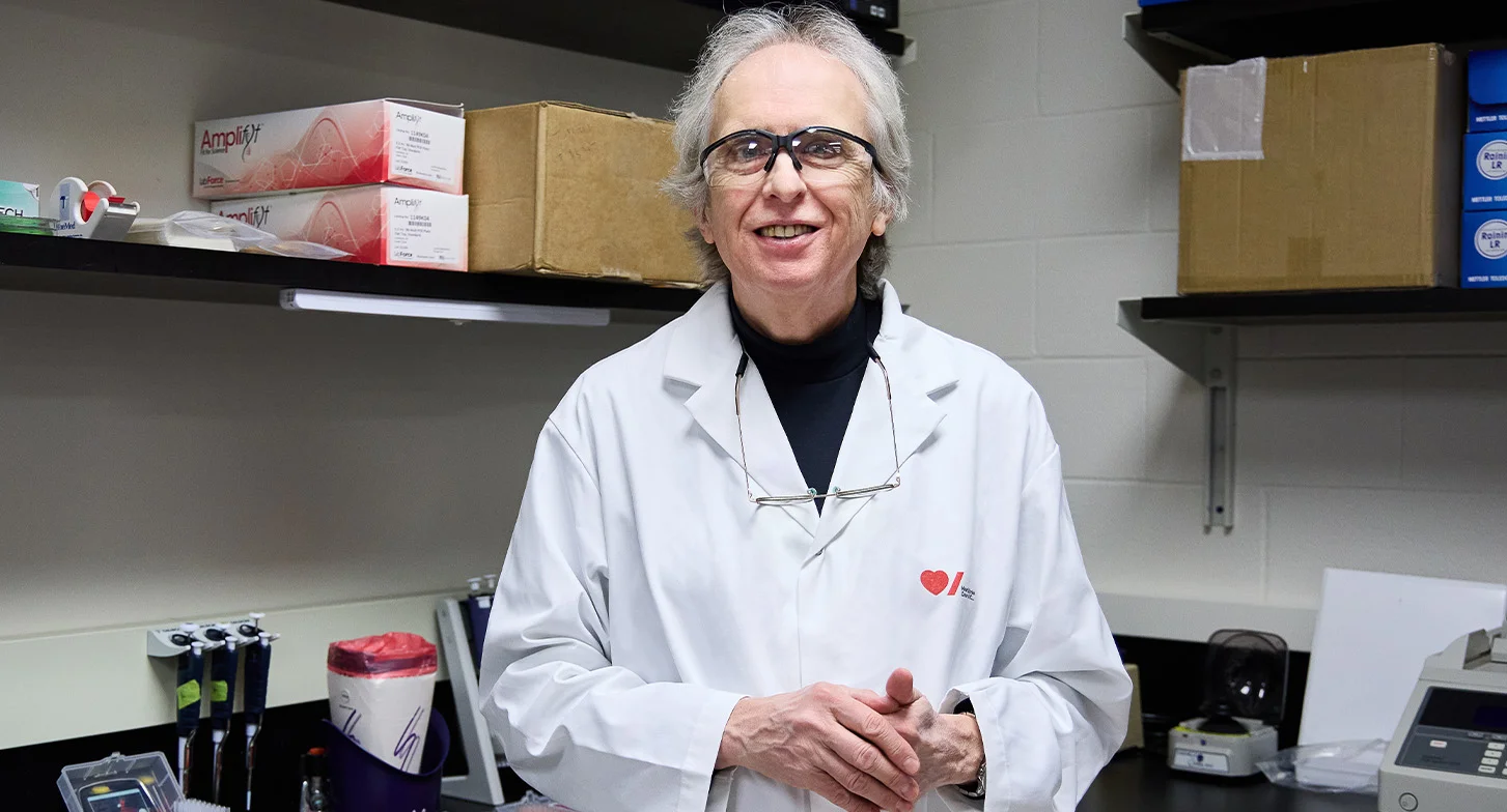 Dr. Robert Hegele stands smiling in his lab.