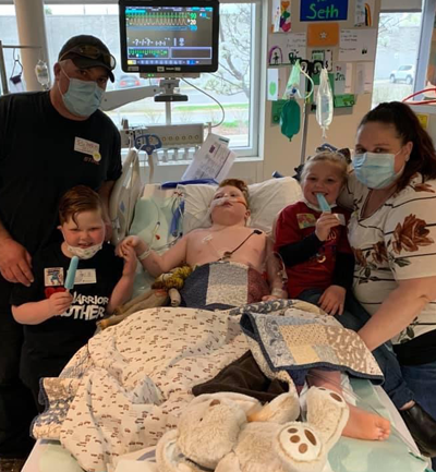 Seth and his family at the hospital next to his bed.