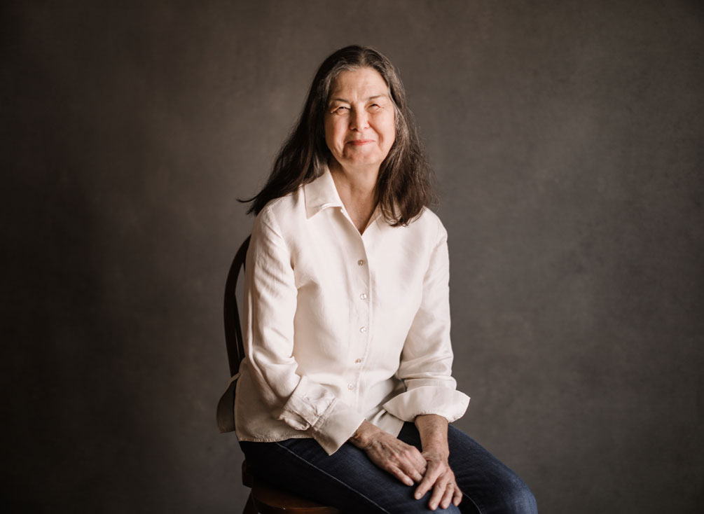 Heart transplant recipient Donna Hart sitting down and smiling at the camera