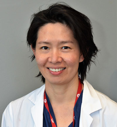 Dr. Sharon Chih in a white lab coat
