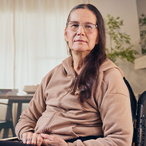 Lynne seated on her wheelchair.