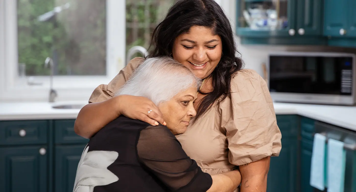 Suji Krishnan hugging her daughter, Rukmini Halliwell.