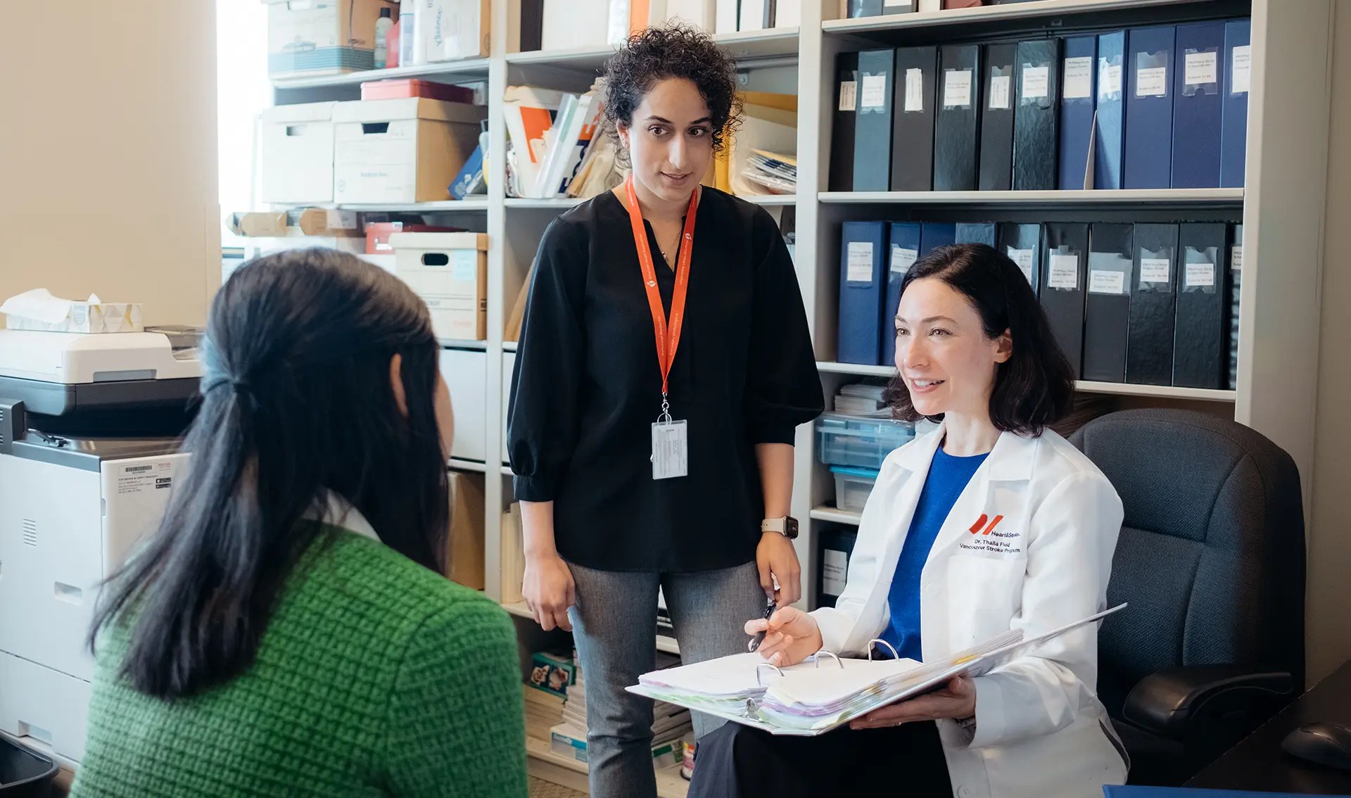 Dr. Thalia Field talks to her research coordinator, Afifa Humair, and Farnaz Sahragard , Dr. Field’s research assistant.