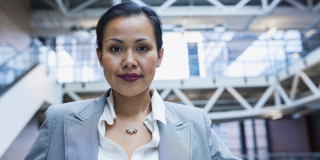 An indigenous woman pictured in a professional setting.