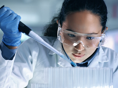 A woman scientist examines test tubes