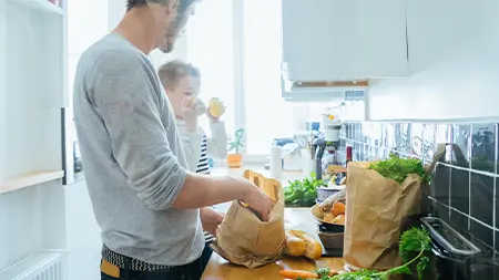 A father and son preparing a meal in the kitchen