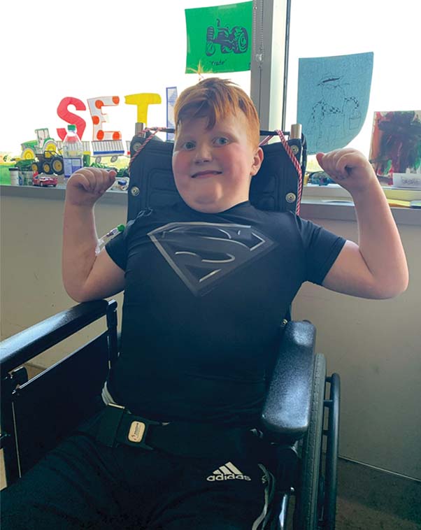 Seth Nottley poses while wearing a superman t-shirt