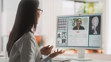 A woman doctor video conferencing her patient.