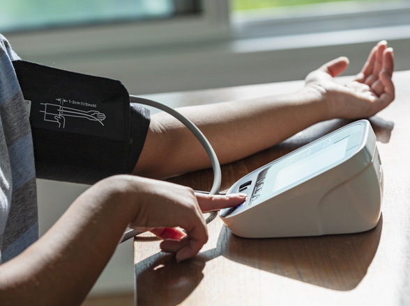 A person using a blood pressure monitor