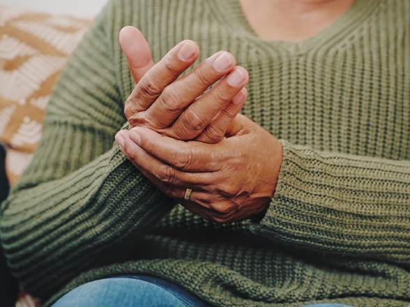 A woman rubbing her palms, implying pain