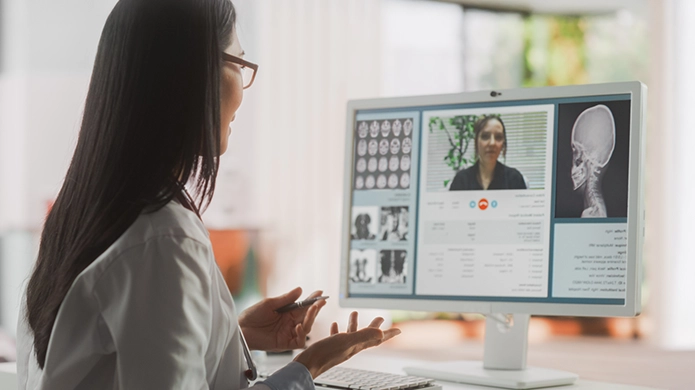 A woman doctor video conferencing her patient.