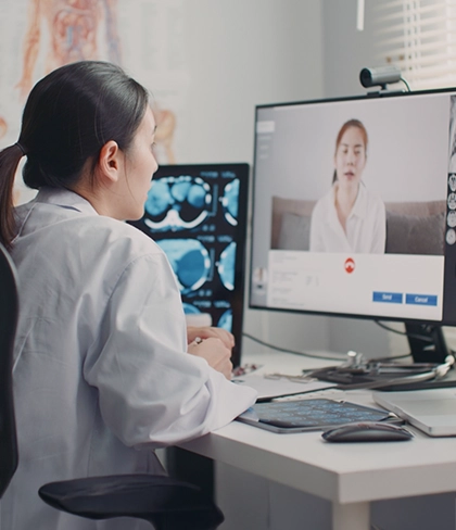A woman doctor video conferencing her patient.