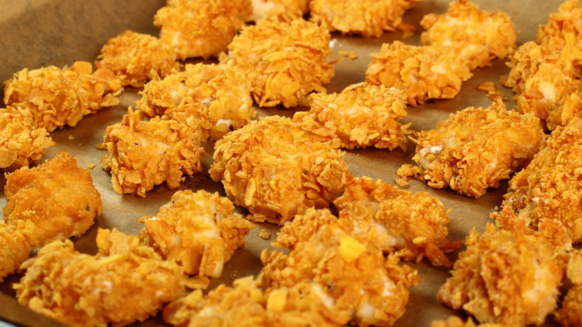 crunchy chicken pieces on a baking sheet