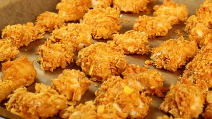 crunchy chicken pieces on a baking sheet 